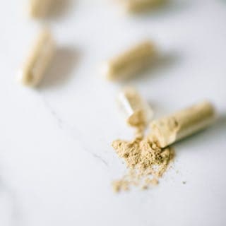 Supplement capsules and powder arranged on a clean workspace