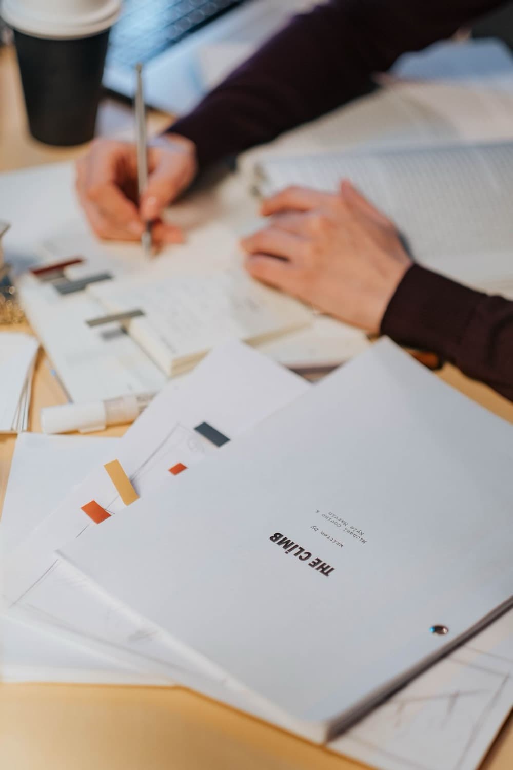 Hands marking up a printed formula and label readiness review